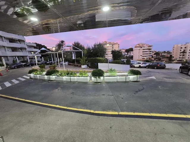 a view of a swimming pool with a table and chairs under an umbrella