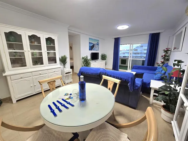 a living room with furniture chandelier and a table
