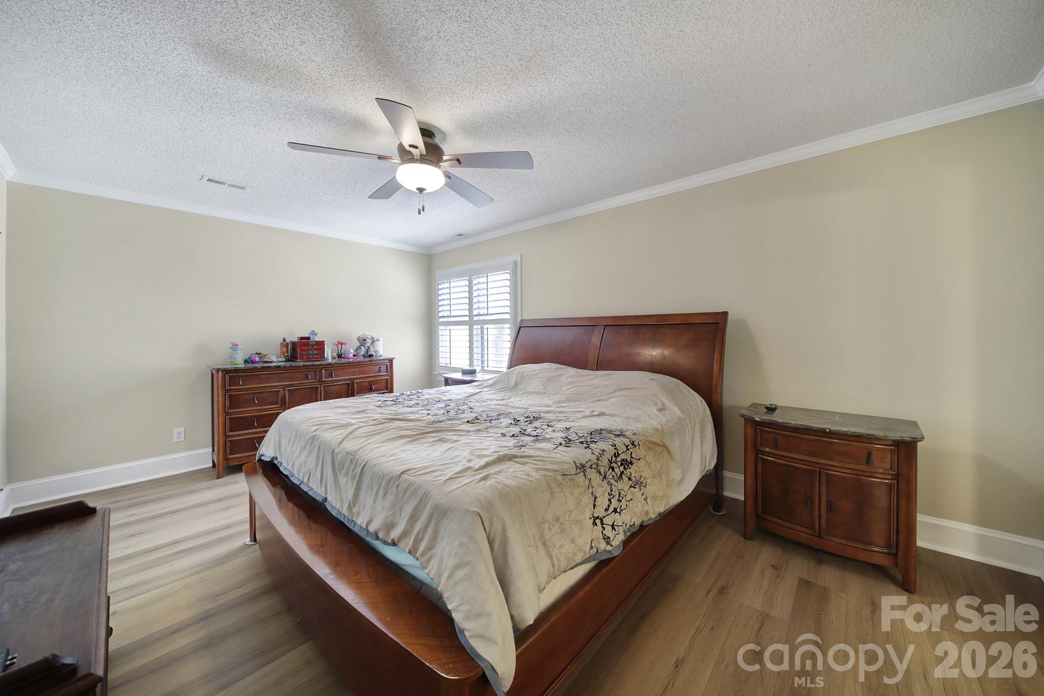 2160 Crosstrail Ridge Rock Hill, SC 29732 - Photo 21 of 37 a bedroom with a bed and a chandelier