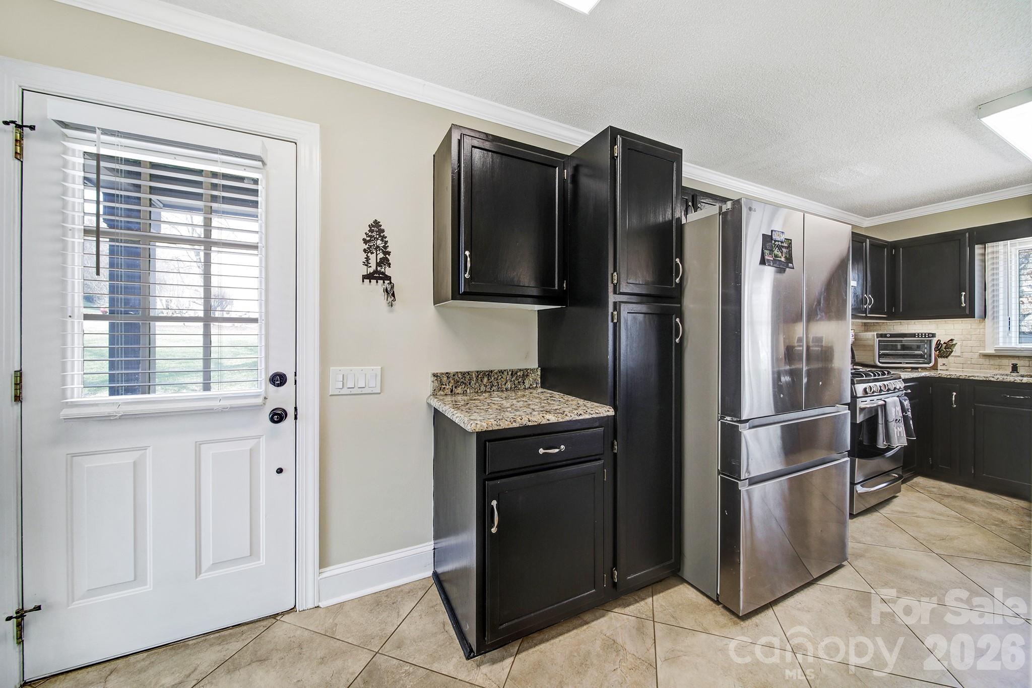 2160 Crosstrail Ridge Rock Hill, SC 29732 - Photo 9 of 37 a kitchen with stainless steel appliances granite countertop a refrigerator stove and oven