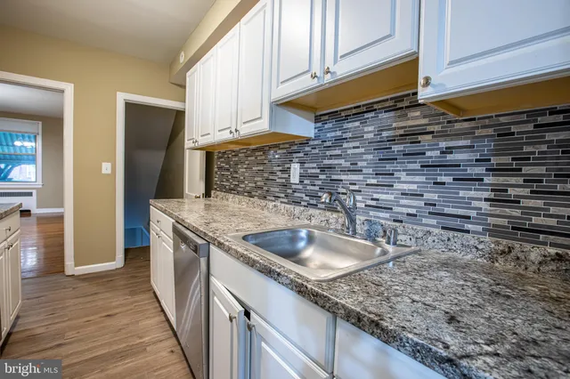 a kitchen with a sink and cabinets