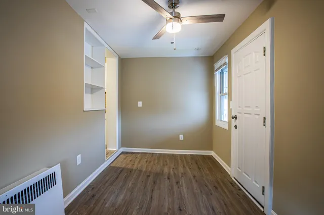 a view of room with window and wooden floor