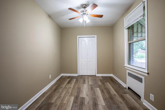 a view of room with a ceiling fan and window