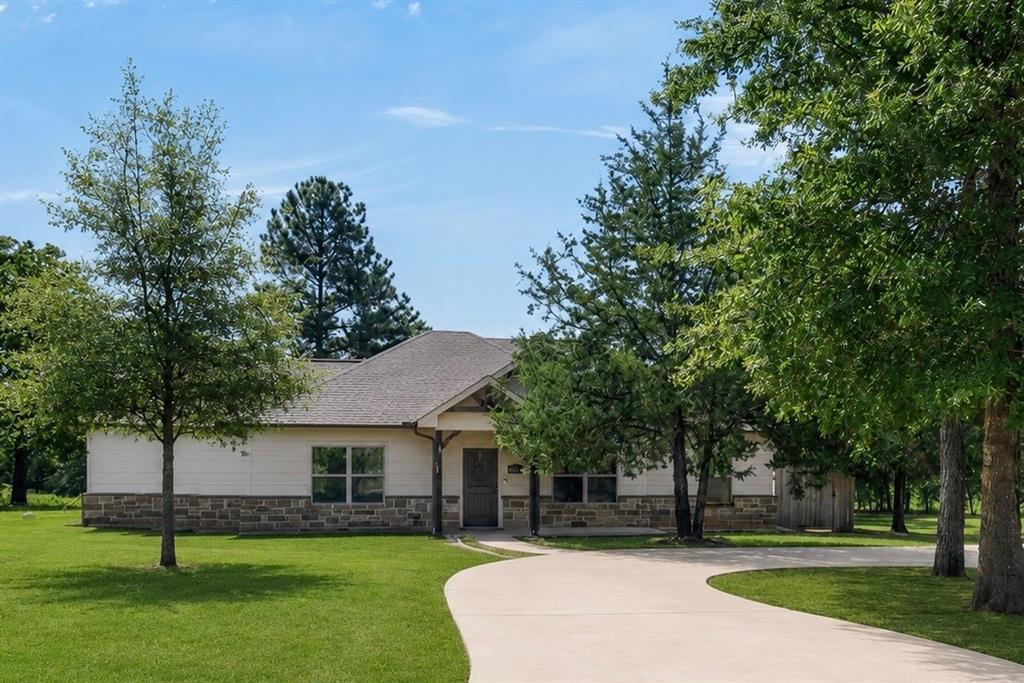 531 VZ County Road Eustace, TX 75124 - Photo 35 of 35 Single-story residence featuring a partial stone facade, covered entry, and a curved concrete driveway