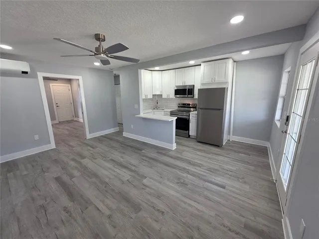 a kitchen with a refrigerator stove and microwave