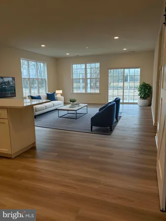 a living room with furniture window and wooden floor