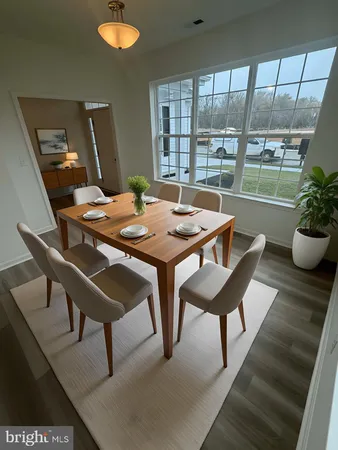 a dining room with furniture and window