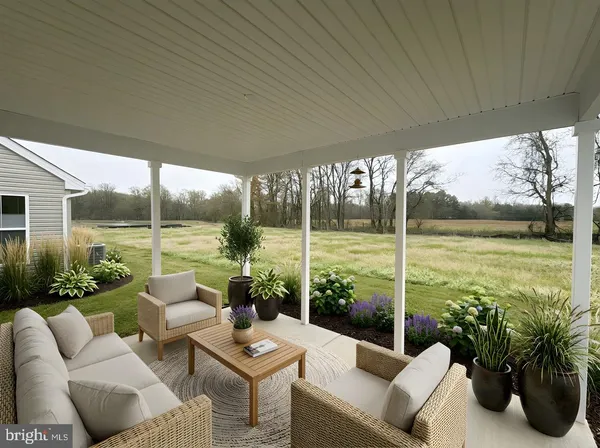 a living room with patio furniture and garden view