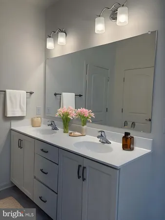 a bathroom with a sink double vanity granite and a mirror