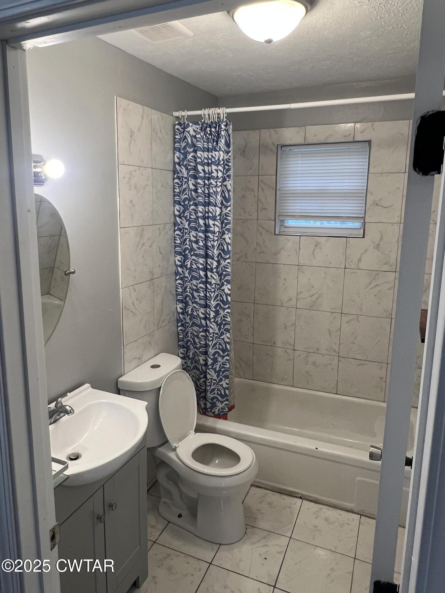134 Liddon Street Jackson, TN 38301 - Photo 12 of 13 a bathroom with a toilet a sink and shower