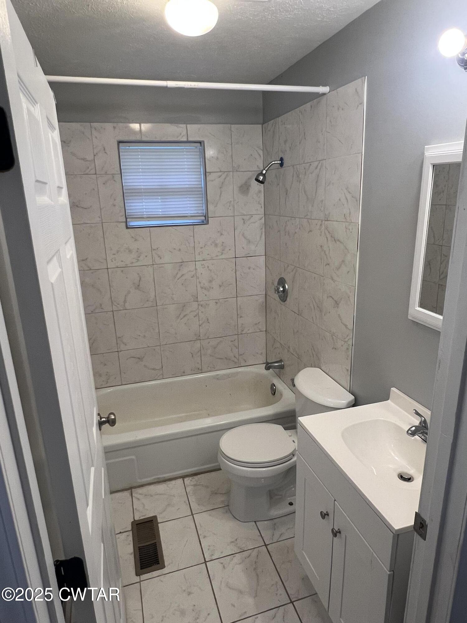 134 Liddon Street Jackson, TN 38301 - Photo 9 of 13 a bathroom with a sink a toilet and shower