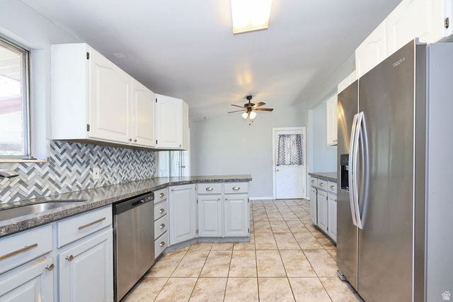 1272 Cook Street Ogden, UT 84404 - Photo 11 of 46 Kitchen featuring a chevron tile backsplash, stainless steel appliances, granite-style countertops, white upper cabinetry, and light gray lower cabinetry