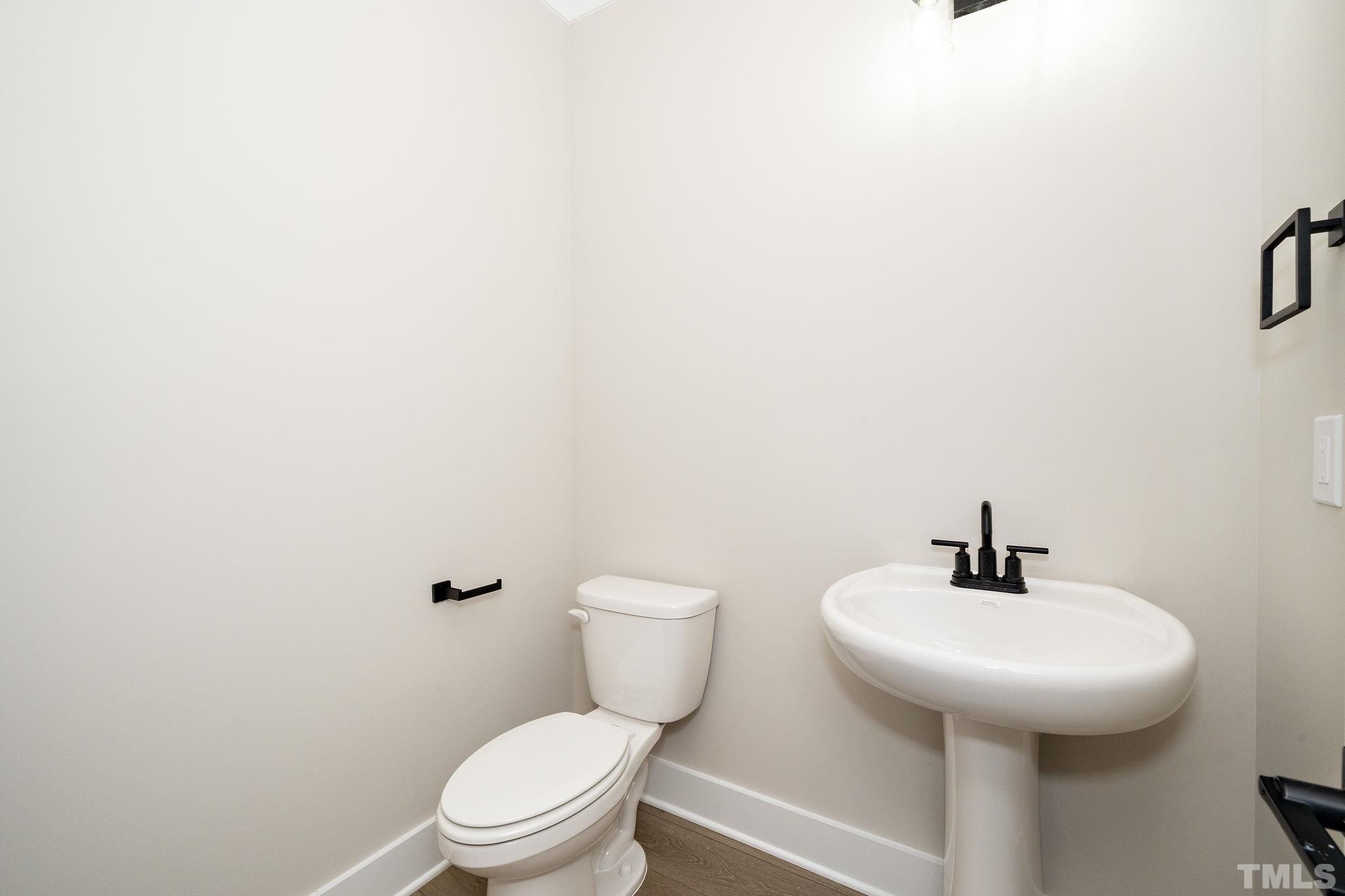 6104 Fox Raleigh, NC 27616 - Photo 11 of 54 a bathroom with a sink a toilet and a mirror