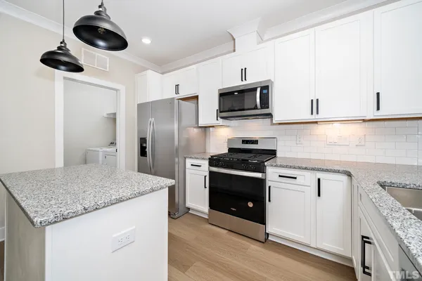 a view of kitchen with sink and wooden floor