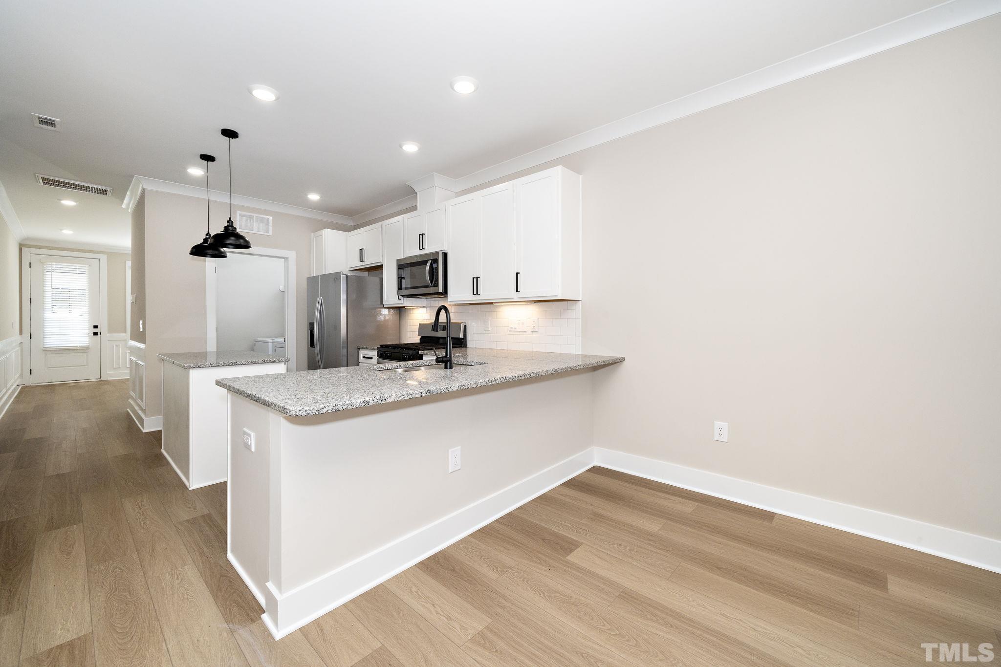 6104 Fox Raleigh, NC 27616 - Photo 13 of 54 a view of kitchen with sink and wooden floor