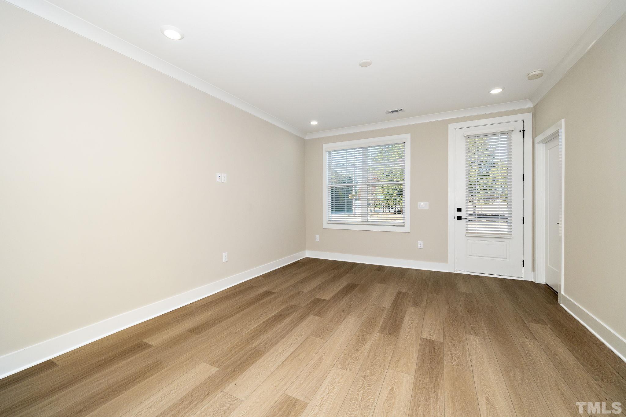 6104 Fox Raleigh, NC 27616 - Photo 15 of 54 an empty room with wooden floor and windows