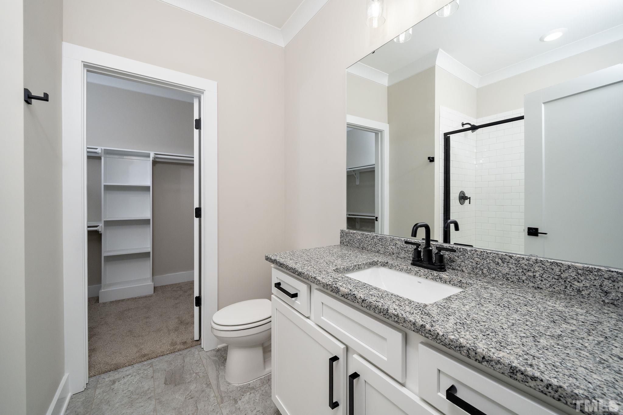 6104 Fox Raleigh, NC 27616 - Photo 17 of 54 a bathroom with a granite countertop sink toilet and shower