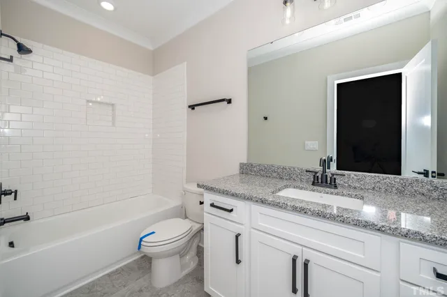 a bathroom with a granite countertop sink mirror and double
