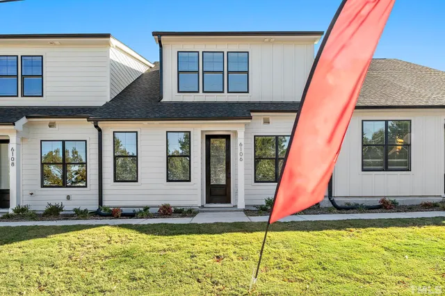 a view of a house with swimming pool and sitting area