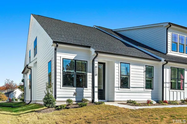 a kitchen with stainless steel appliances granite countertop a sink a stove and a wooden floors
