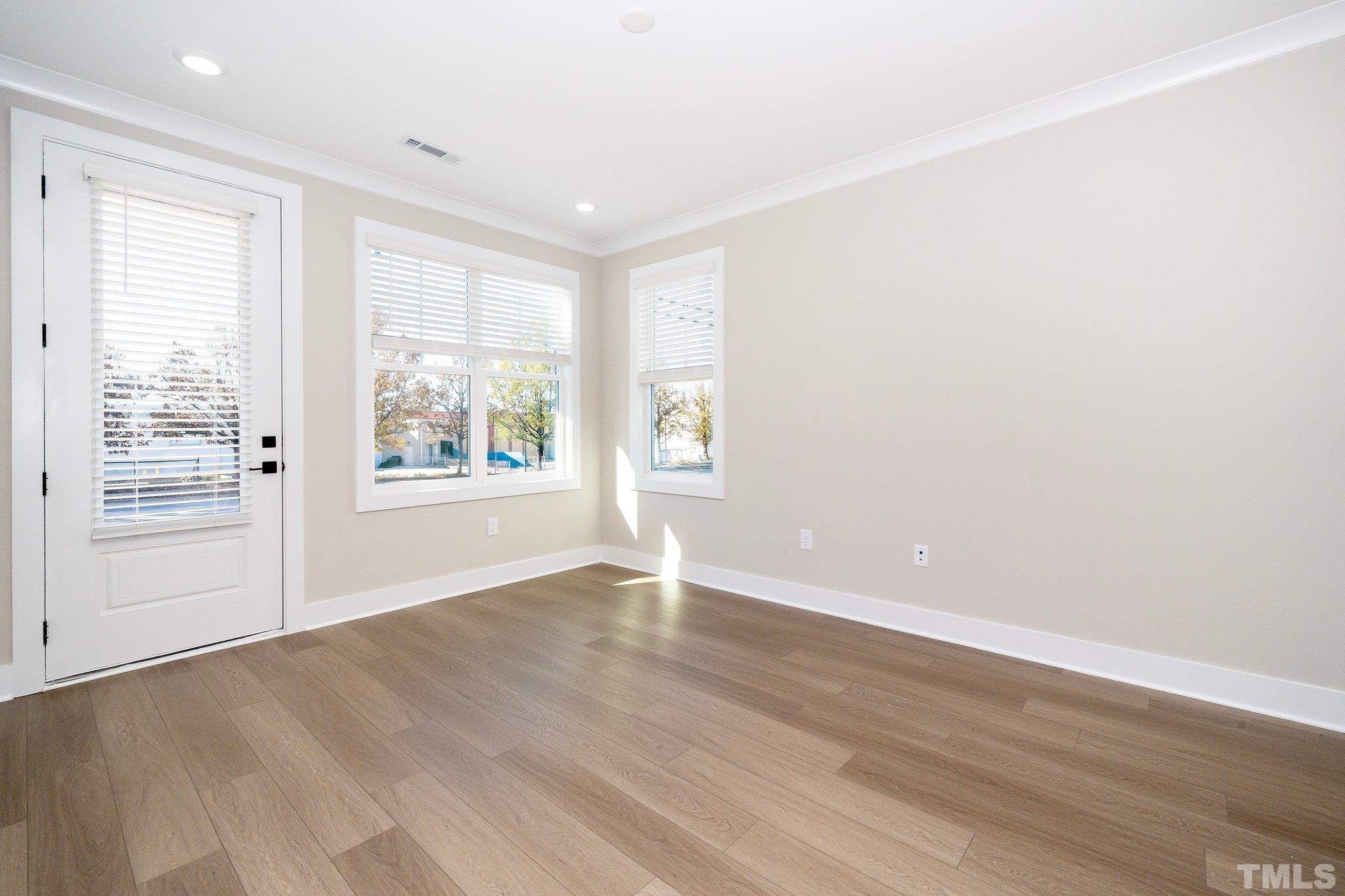 6104 Fox Raleigh, NC 27616 - Photo 35 of 54 an empty room with wooden floor and windows