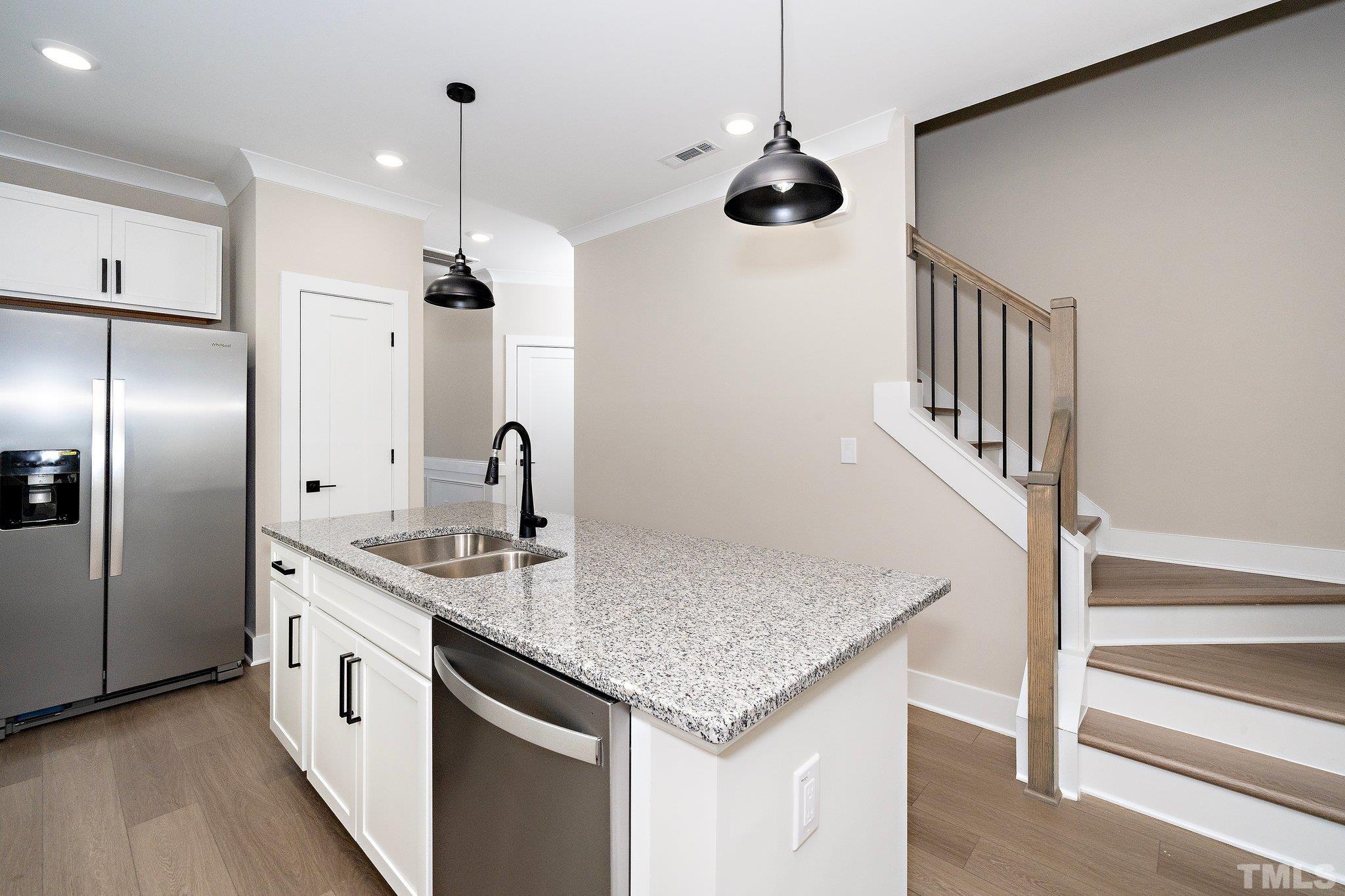 6104 Fox Raleigh, NC 27616 - Photo 38 of 54 a kitchen with stainless steel appliances granite countertop a sink and a refrigerator