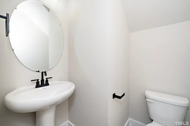 a bathroom with a granite countertop double vanity sink shower and a mirror