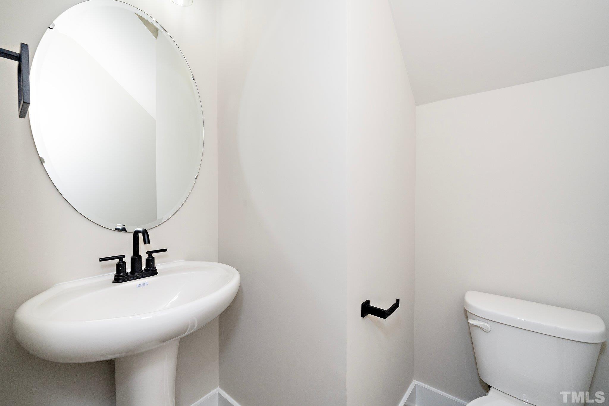 6104 Fox Raleigh, NC 27616 - Photo 41 of 54 a bathroom with a sink a mirror and toilet