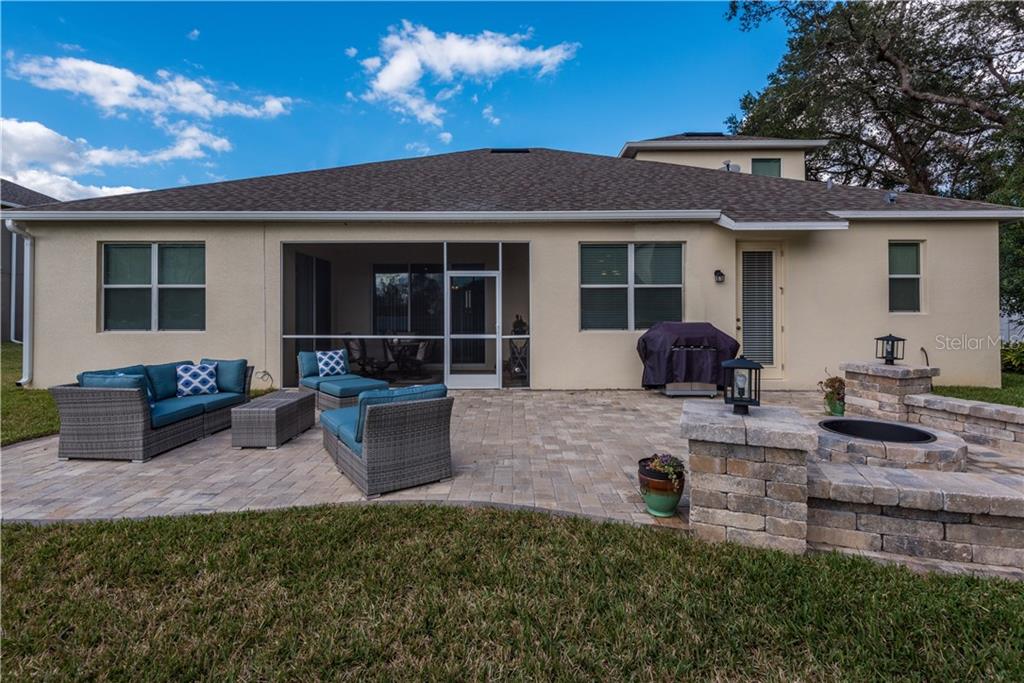 395 Pine Tree Road Lake Mary, FL 32746 - Photo 22 of 25 Exterior Back View showing Screened Porch & Paver Patio w/ Firepit