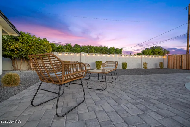 a backyard of a house with table and chairs