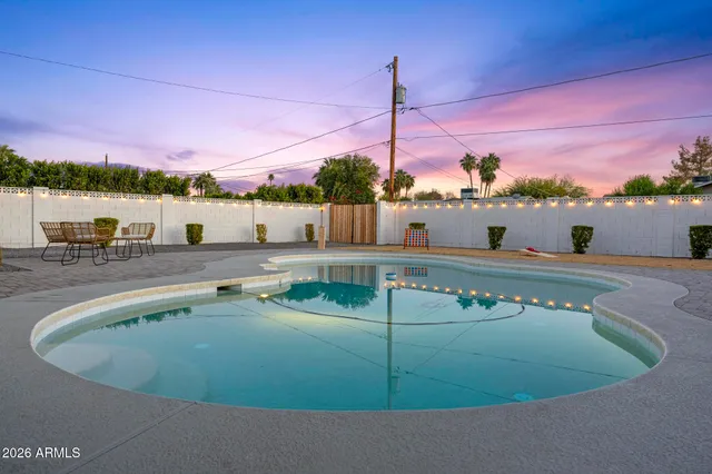 a large bed sitting in a bedroom next to a window