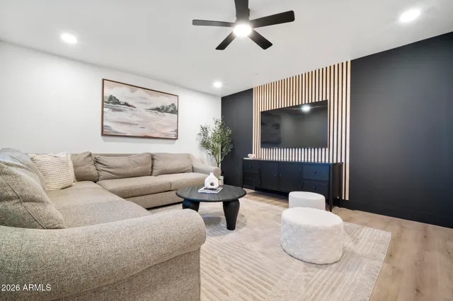 a living room with furniture a dining table and a potted plant