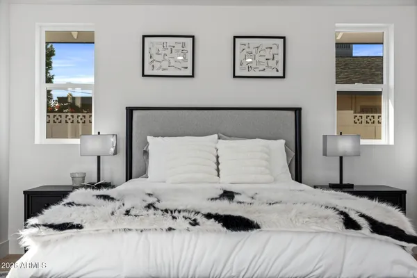 a bedroom with a bed and a night stand
