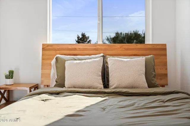 a living room with furniture a rug and white walls