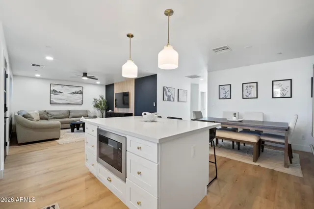 a living room with furniture a ceiling fan and a window