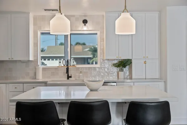 a kitchen with a sink stove top oven and cabinets
