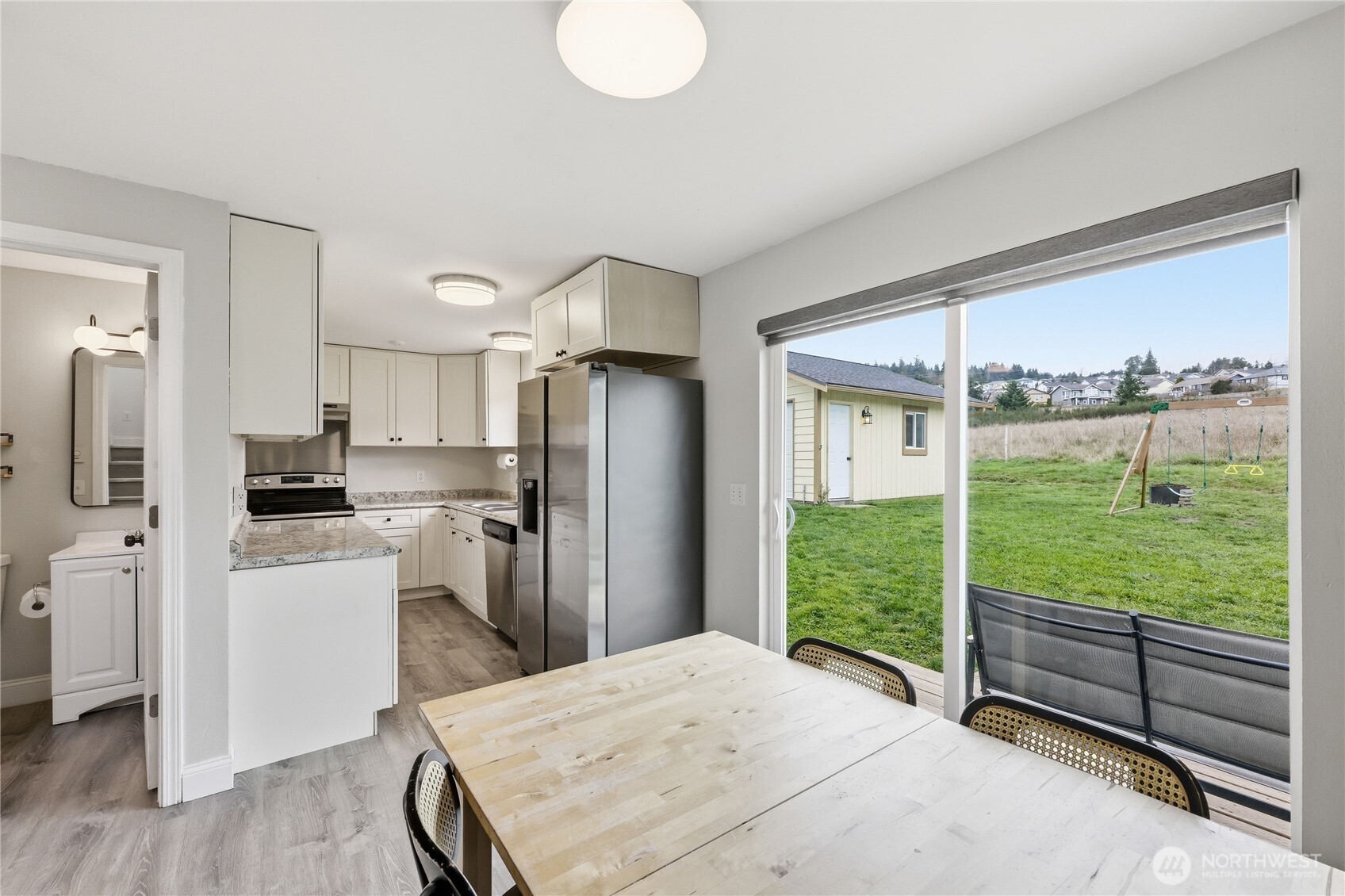 110 Alpine Loop Sequim, WA 98382 - Photo 12 of 36 a kitchen with a refrigerator and a view of living room