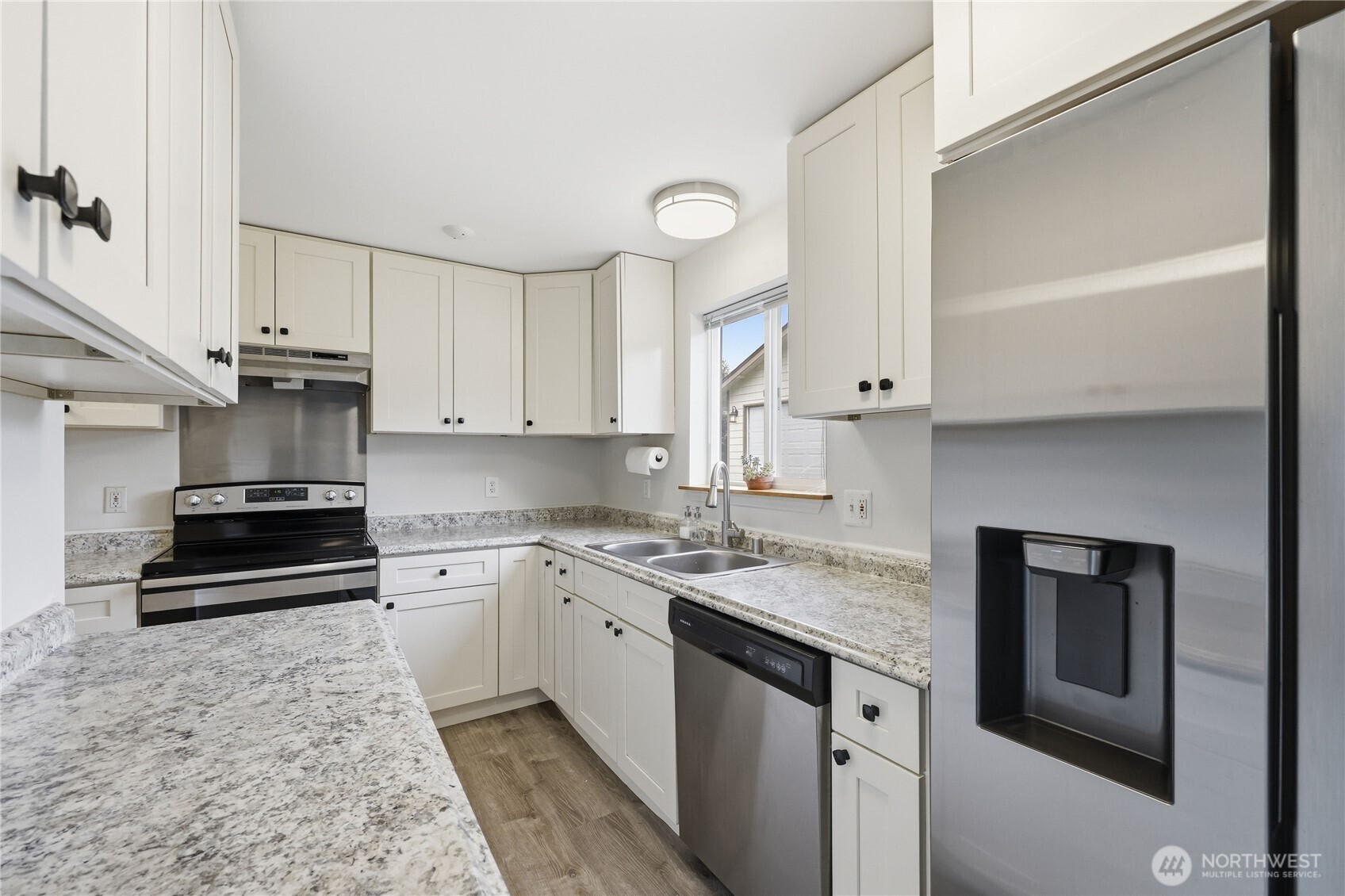110 Alpine Loop Sequim, WA 98382 - Photo 13 of 36 a kitchen with a sink stove and cabinets