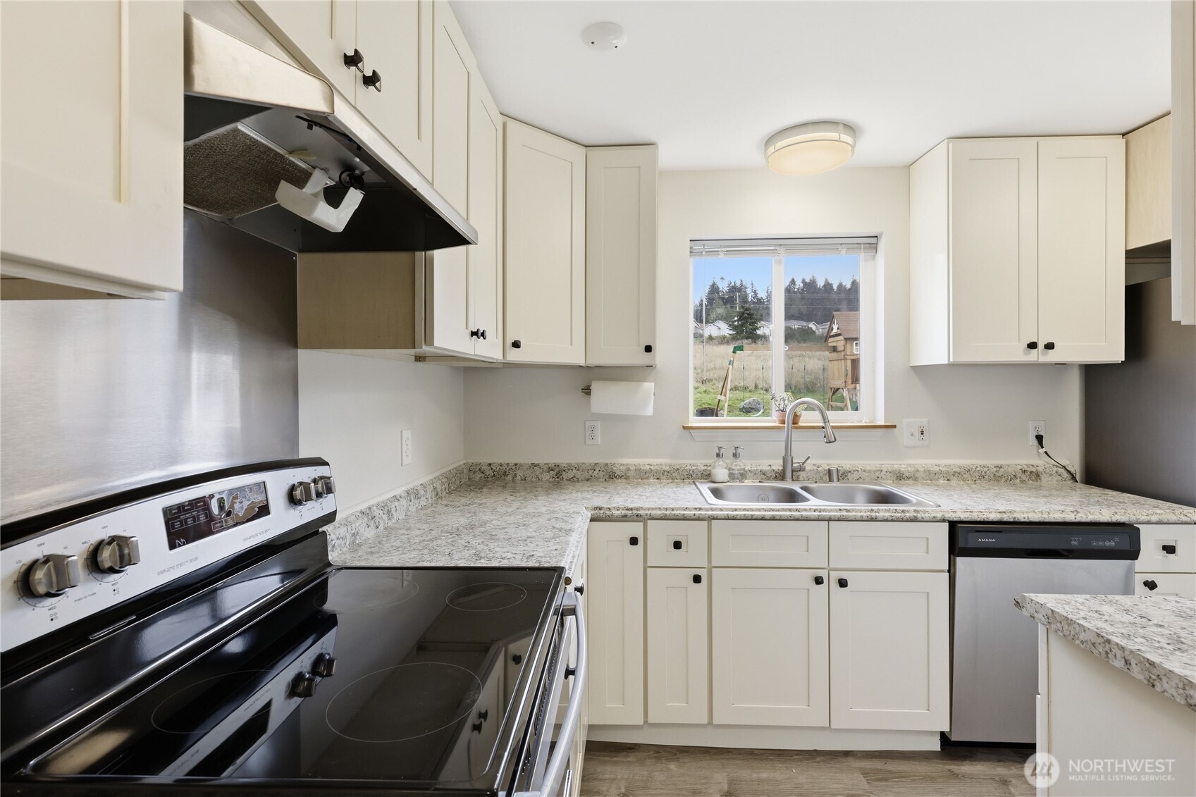 110 Alpine Loop Sequim, WA 98382 - Photo 15 of 36 a kitchen with a sink appliances and cabinets