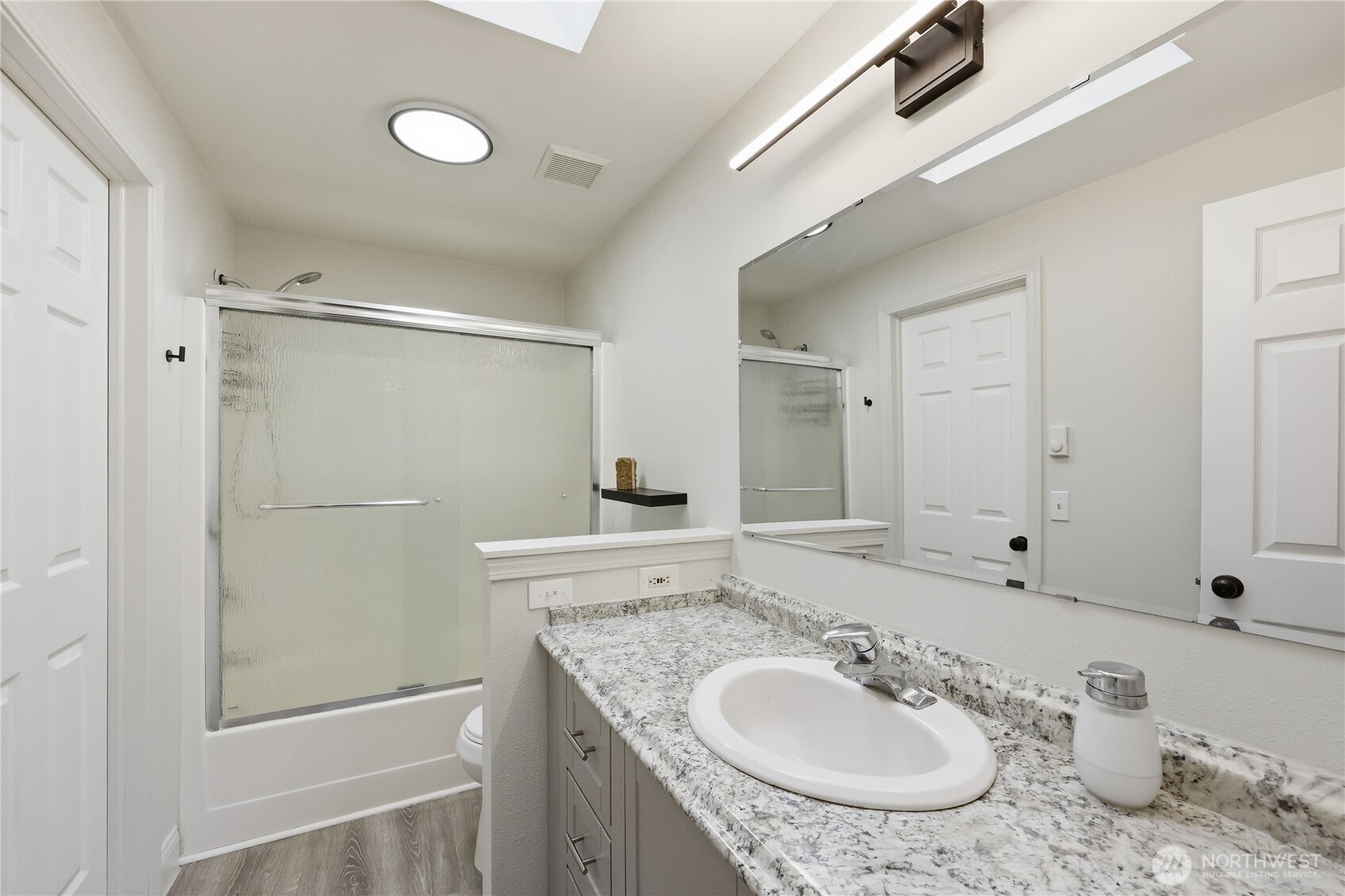 110 Alpine Loop Sequim, WA 98382 - Photo 22 of 36 a bathroom with a granite countertop sink and a mirror