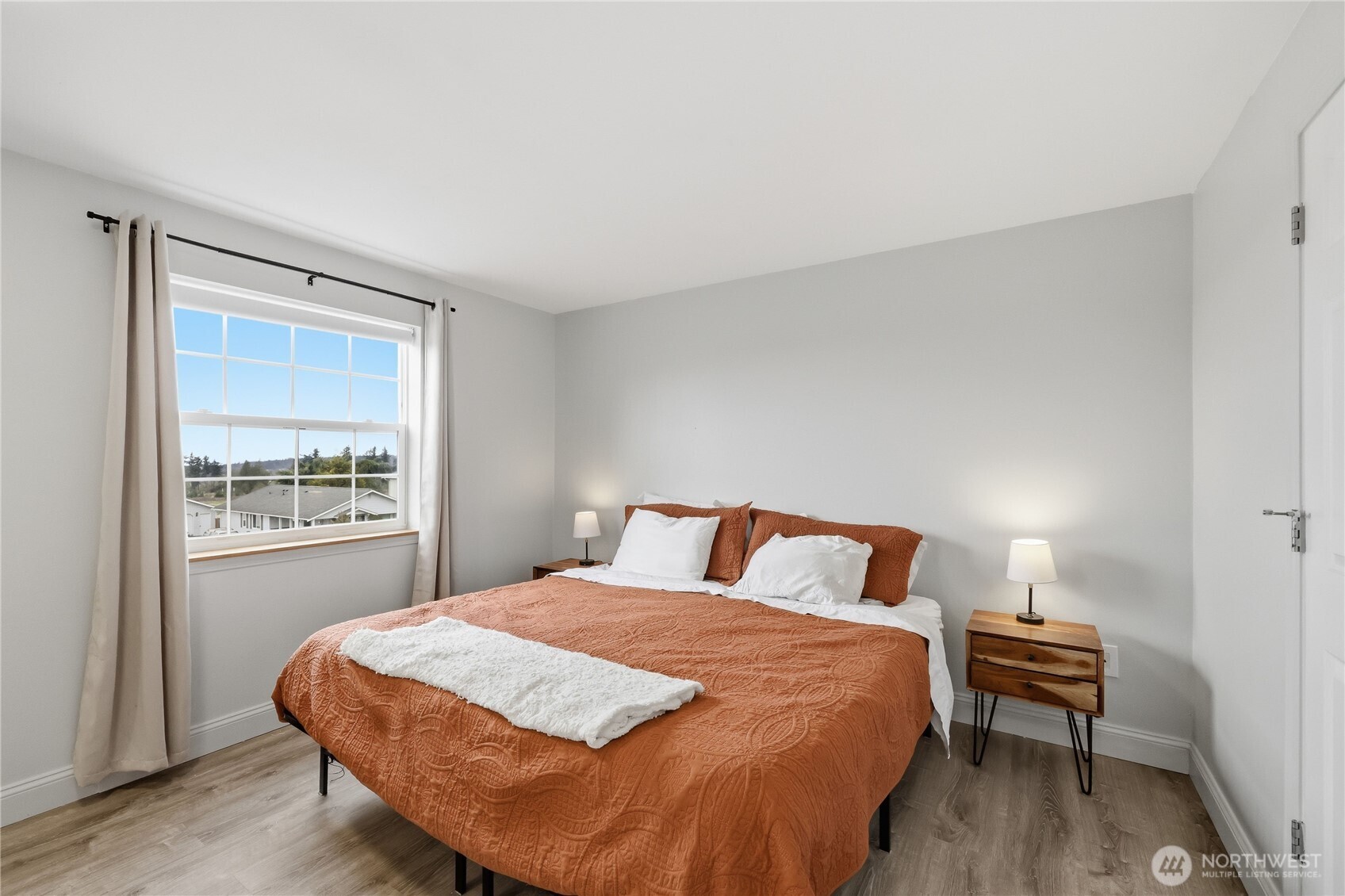 110 Alpine Loop Sequim, WA 98382 - Photo 23 of 36 a bedroom with a bed and wooden floor