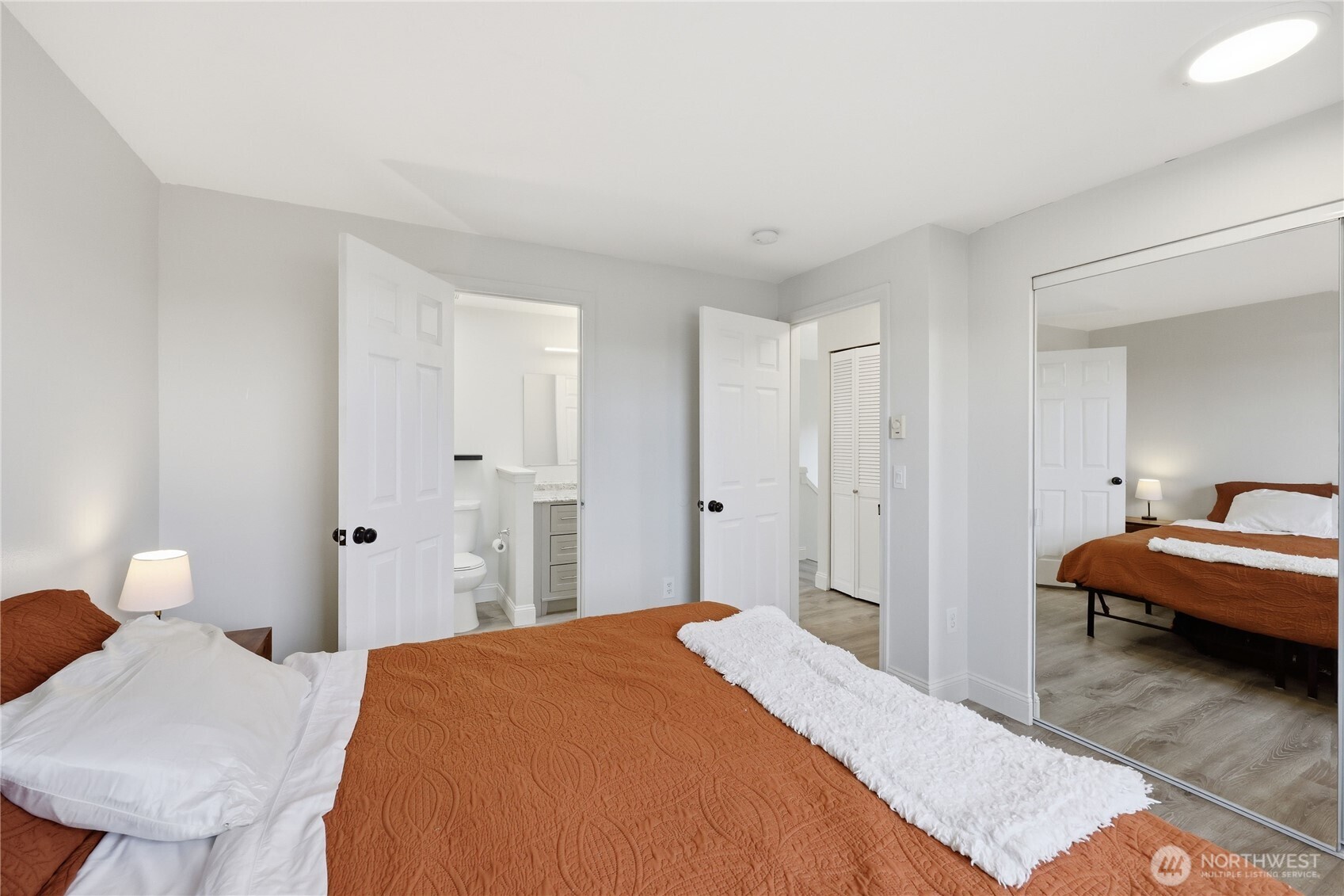 110 Alpine Loop Sequim, WA 98382 - Photo 24 of 36 a bedroom with a bed and a lamp