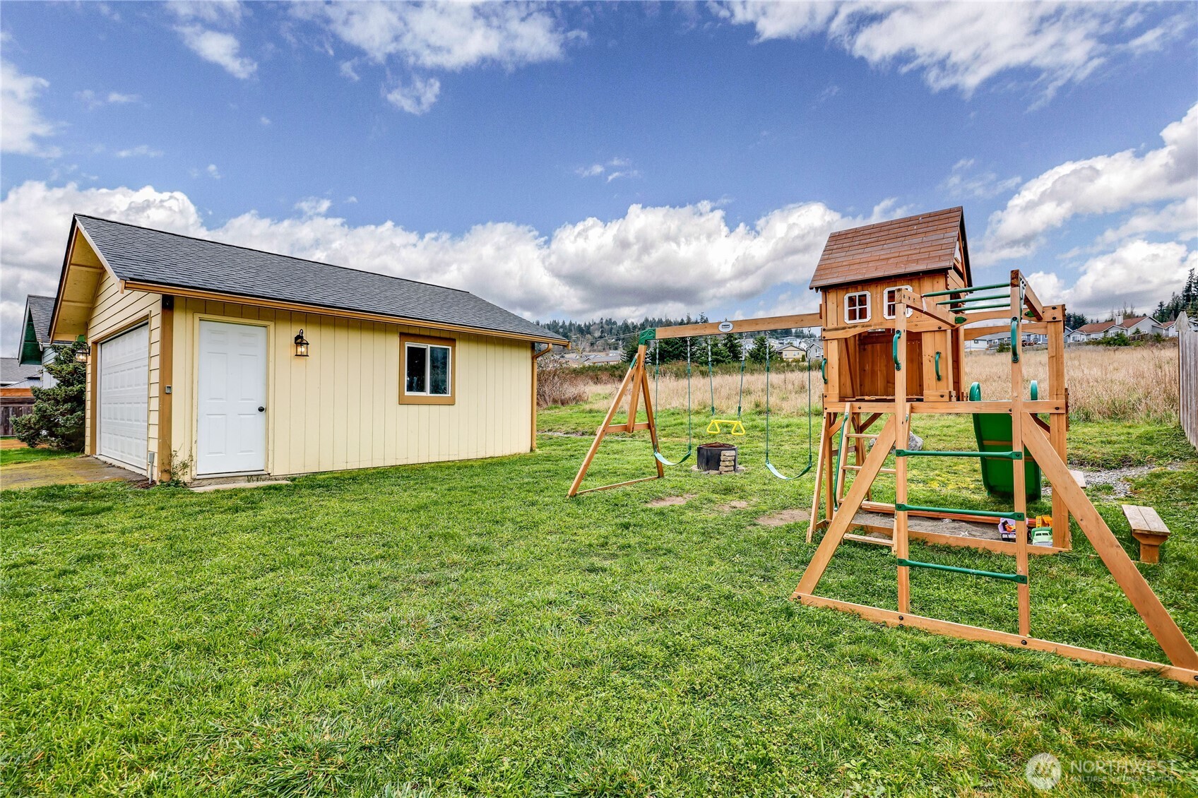 110 Alpine Loop Sequim, WA 98382 - Photo 28 of 36 a backyard of a house with plants and wooden fence