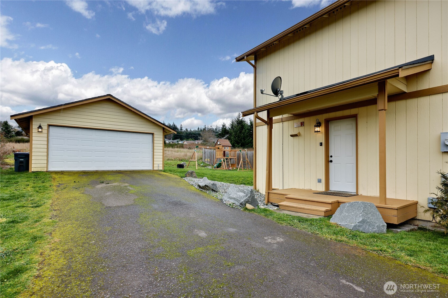 110 Alpine Loop Sequim, WA 98382 - Photo 31 of 36 a front view of a house with a yard and garage