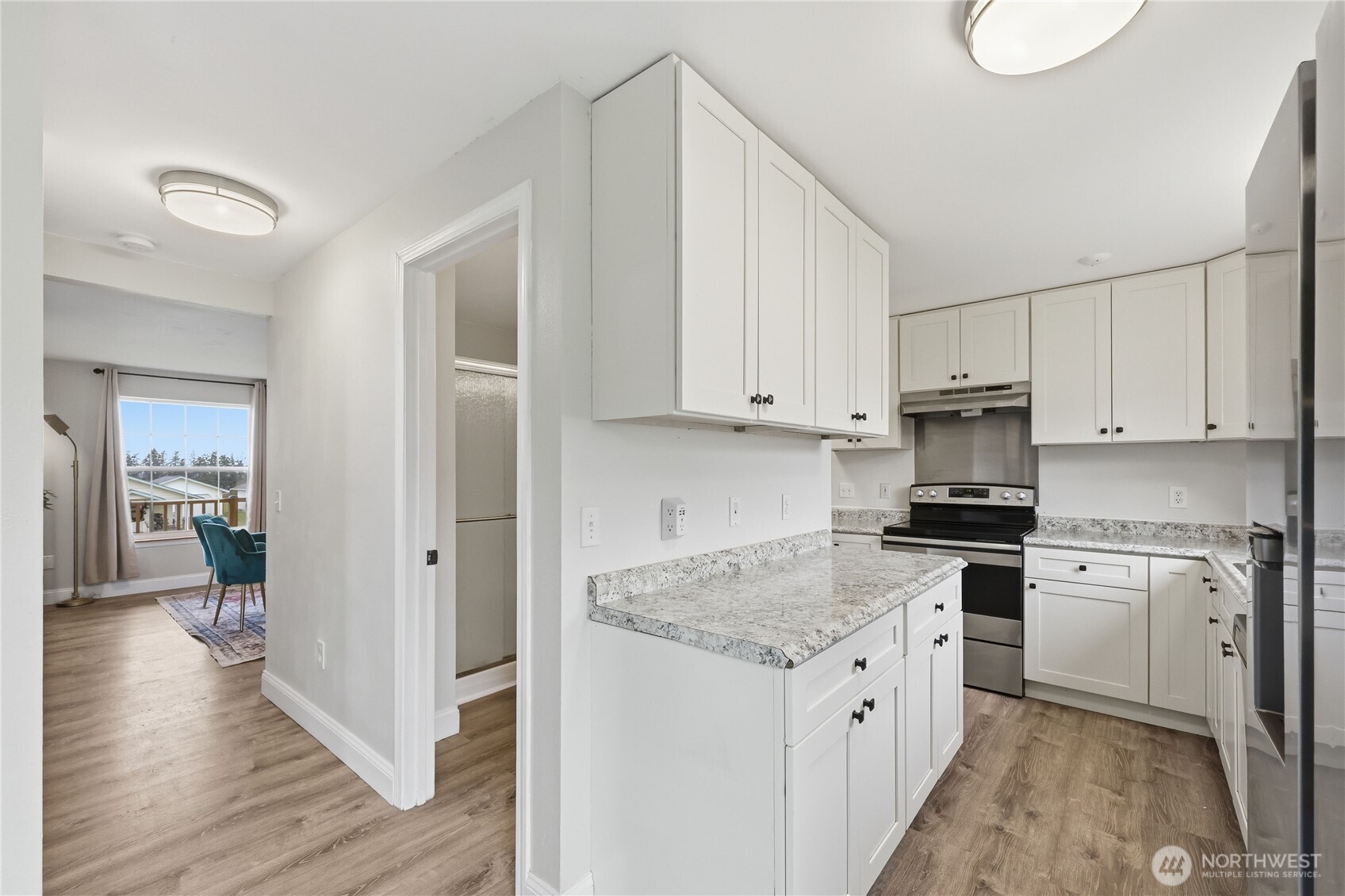 110 Alpine Loop Sequim, WA 98382 - Photo 10 of 36 a kitchen with granite countertop white cabinets and white appliances