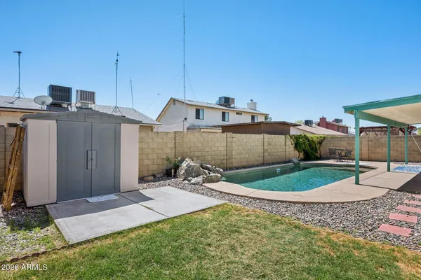 a view of a house with backyard sitting area and garden