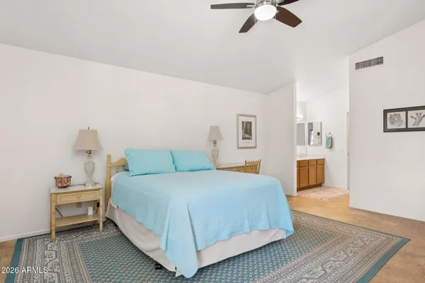 a bedroom with a bed and wooden floor