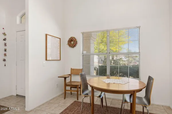 a dining room with furniture and a window