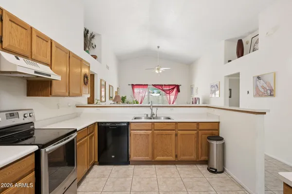 a kitchen with a refrigerator sink and cabinets