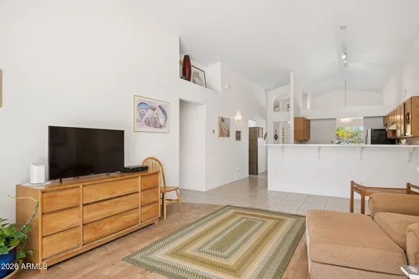 a living room with furniture and a floor to ceiling window